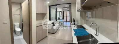 Modern apartment interior with open kitchen and cozy living area