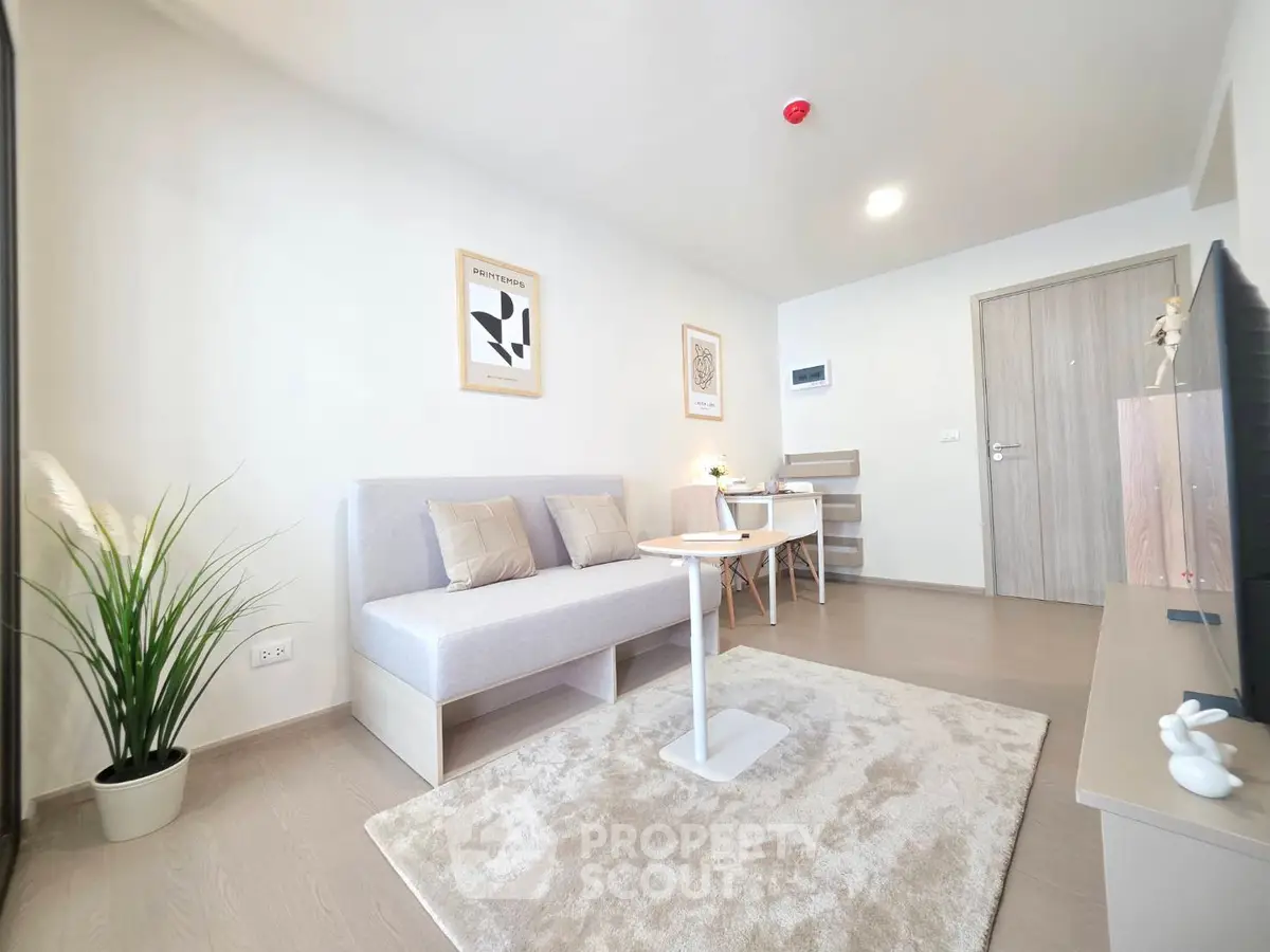 Modern living room with cozy seating and stylish decor in a bright apartment.