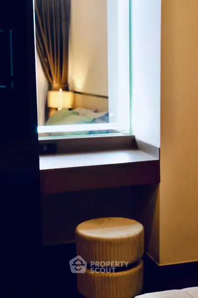 Cozy bedroom corner with stylish mirror and soft lighting
