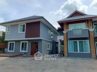Spacious modern two-story house with a large driveway and elegant architectural design.