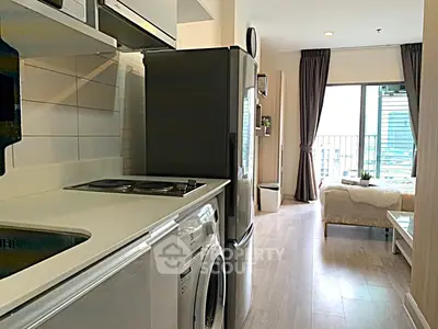 Modern apartment interior with kitchen and cozy bedroom, featuring large window with city view.