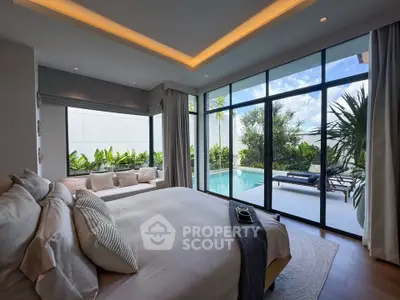 Luxurious bedroom with pool view and floor-to-ceiling windows in modern villa