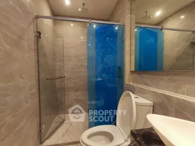 Modern bathroom with glass shower and sleek fixtures in luxury apartment