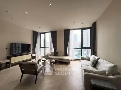 Spacious modern living room with city view, elegant furniture, and natural light.