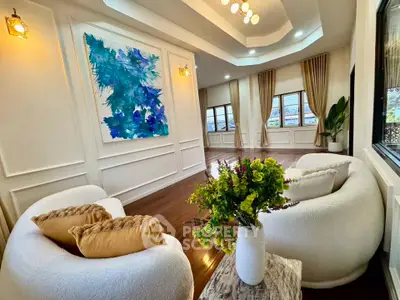 Luxurious living room with elegant decor, plush seating, and large windows offering natural light.