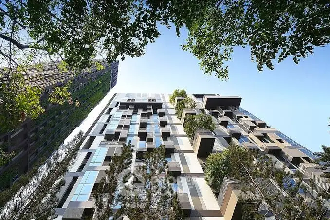 Modern architectural building with lush greenery and unique facade design.