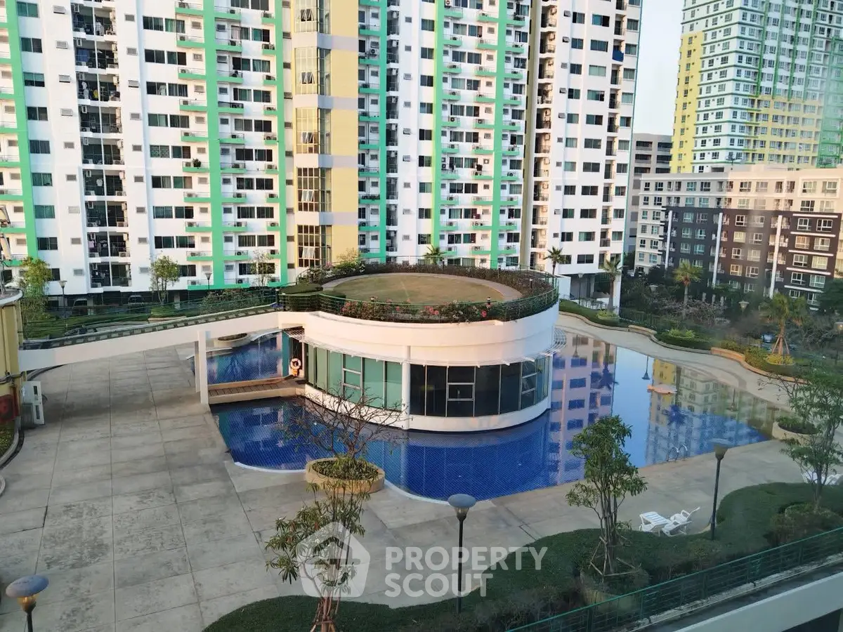 Modern apartment complex with pool and rooftop garden in urban setting