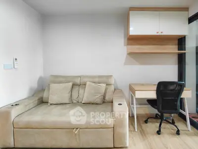 Modern living room with beige sofa and study desk, perfect for cozy relaxation and productivity.