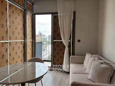 Modern living room with large windows and city view, featuring a cozy sofa and elegant dining table.