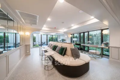 Luxurious modern living room with elegant decor and garden view, perfect for relaxation and entertaining.