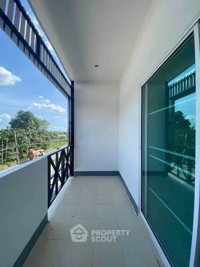 Spacious balcony with scenic view and modern glass door