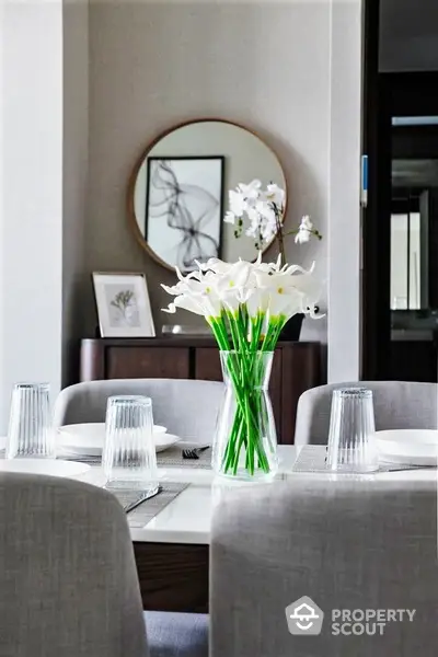 Elegant dining area with modern decor and fresh flowers