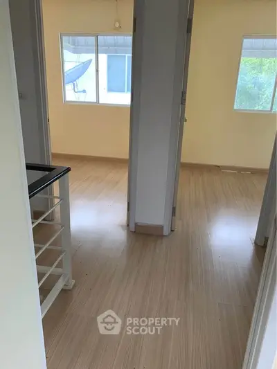 Spacious interior with wooden flooring and natural light, ideal for modern living.