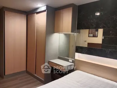 Modern bedroom with sleek wooden wardrobe and stylish decor