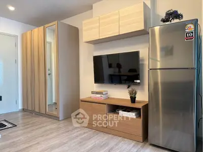 Modern living room with sleek wooden furniture and stainless steel fridge