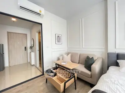 Modern living room with stylish decor and cozy seating in a contemporary apartment.