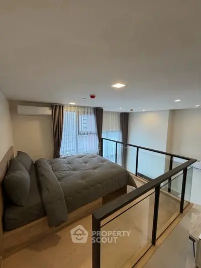 Modern loft bedroom with large windows and sleek design