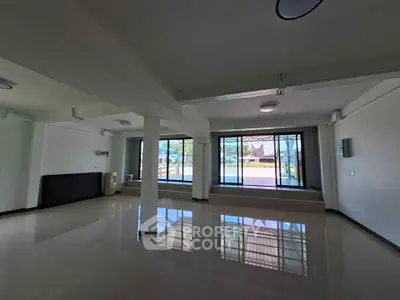 Spacious open-plan interior with large windows offering abundant natural light and modern design.