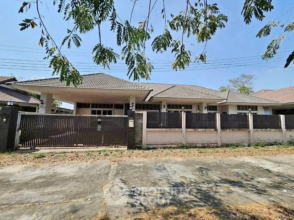 Charming single-story house with spacious front yard and modern fence in a serene neighborhood.