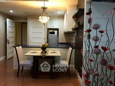 Elegant dining area with modern lighting and stylish decor in a cozy apartment setting.