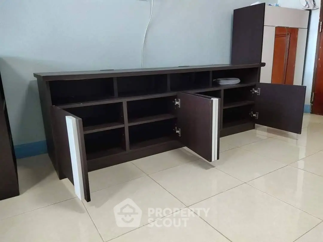 Modern dark wood TV cabinet with open storage on tiled floor