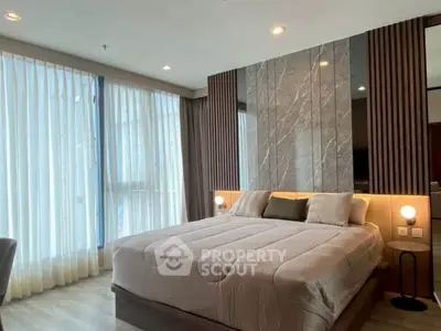 Luxurious bedroom with modern design and floor-to-ceiling windows in upscale apartment.