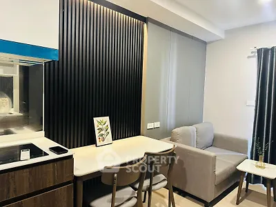 Modern living room with sleek design, featuring a cozy sofa, dining table, and stylish wall paneling.