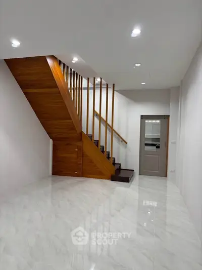 Modern interior with sleek staircase and glossy marble flooring