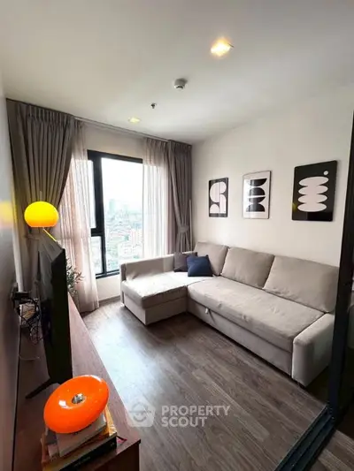 Modern living room with stylish decor and city view from large window.