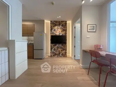 Modern apartment interior with stylish decor and open layout, featuring a kitchen and dining area.