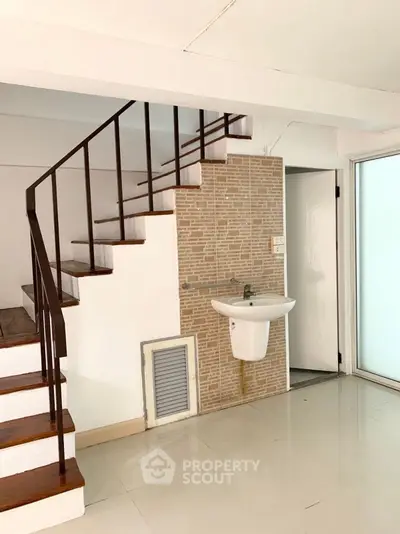 Modern interior with staircase and sink, ideal for creative renovation.