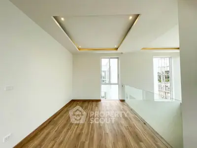 Spacious modern living room with wooden flooring and recessed lighting