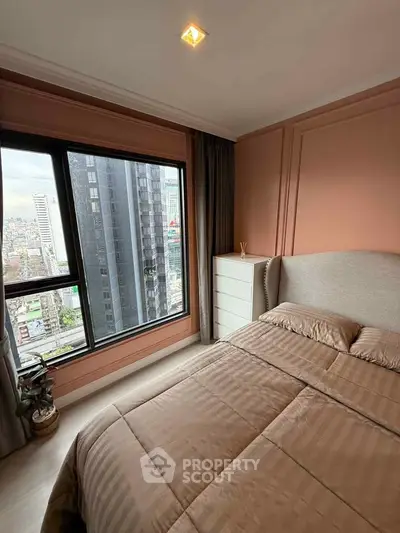 Cozy bedroom with city view, featuring a comfortable bed and modern decor.