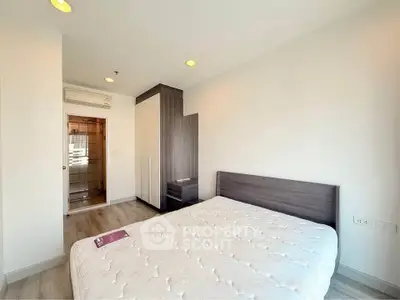Modern bedroom with sleek furniture and natural light, featuring a cozy bed and stylish wardrobe.