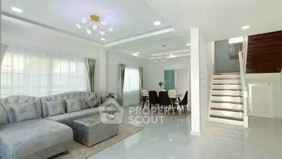 Spacious modern living room with elegant dining area and stylish staircase