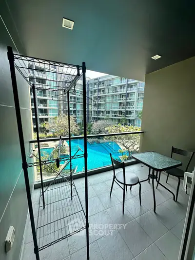 Modern balcony with pool view in luxury apartment complex