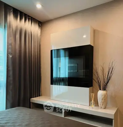 Modern bedroom with sleek built-in TV unit and elegant decor