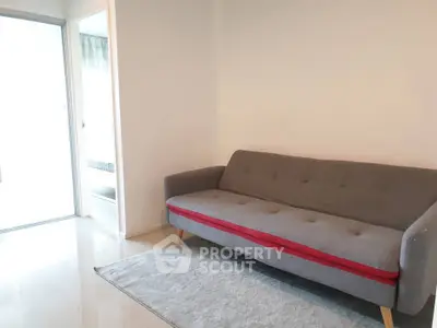 Modern living room with stylish gray sofa and sleek flooring