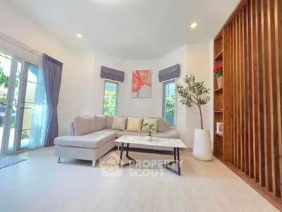 Bright and spacious living room with modern decor and large windows.