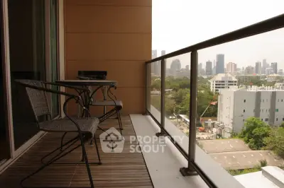 Spacious balcony with city skyline view, perfect for relaxation and enjoying the outdoors.