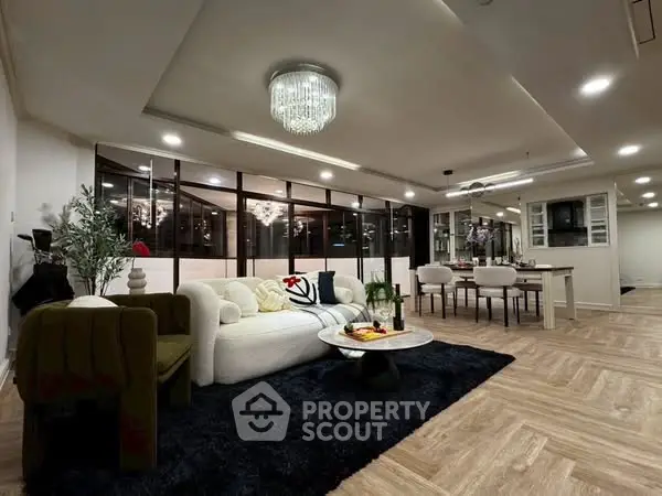 Luxurious open-plan living room with elegant chandelier and modern decor