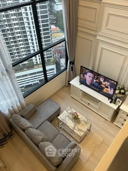 Luxurious high-rise living room with stunning city view, elegant decor, and modern furnishings.