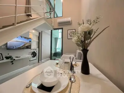 Modern loft apartment with stylish decor, open living area, and elegant dining setup.