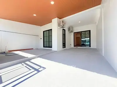 Spacious modern patio with sleek design and air conditioning units, perfect for outdoor relaxation.