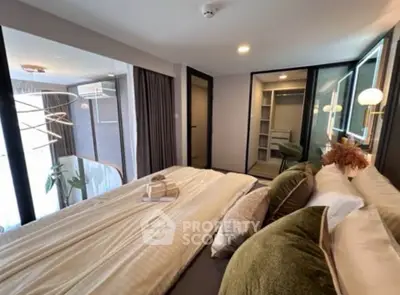 Luxurious bedroom with modern decor and walk-in closet, featuring elegant lighting and plush bedding.