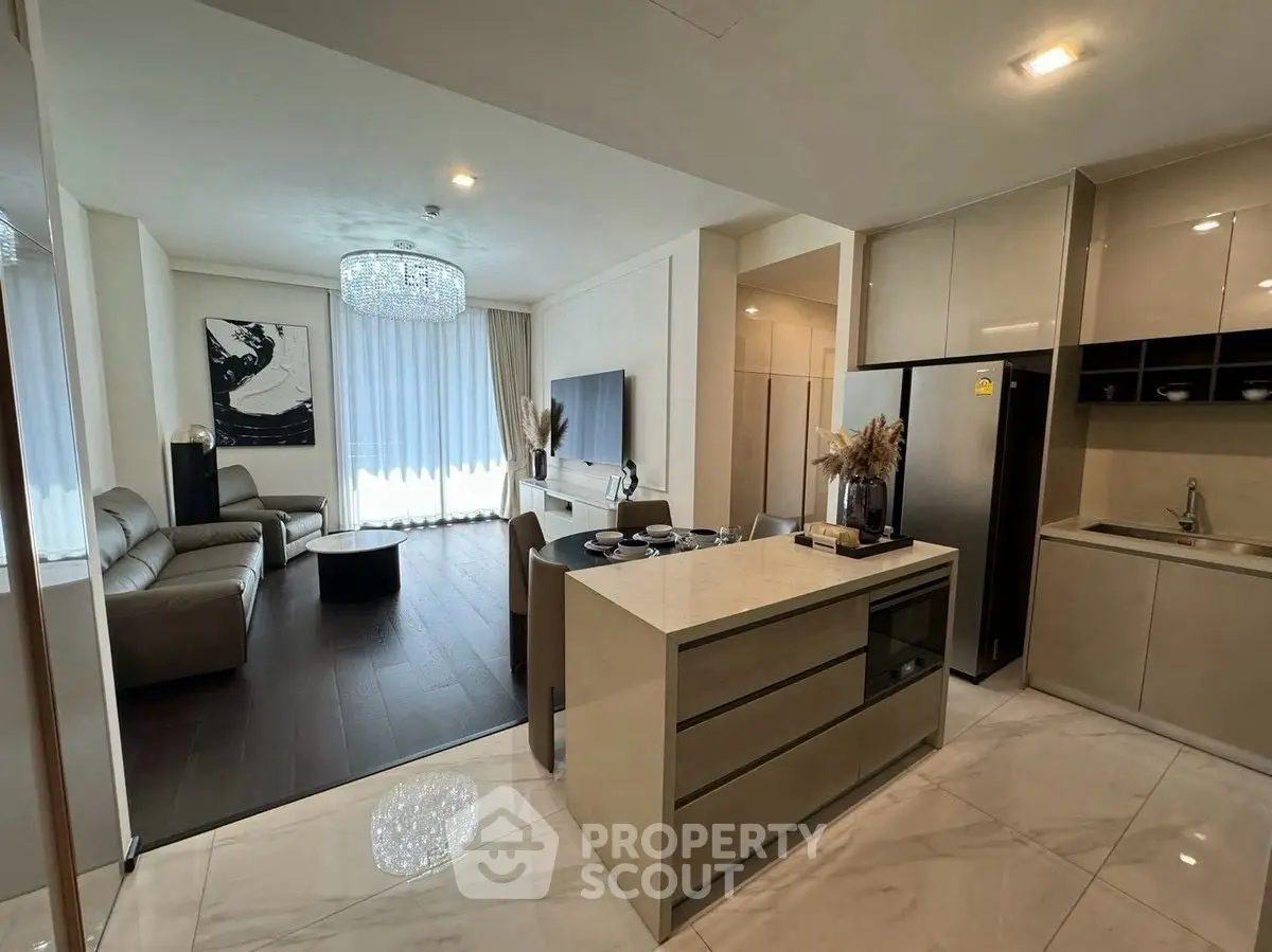 Luxurious open-plan living room and kitchen with modern decor and elegant lighting