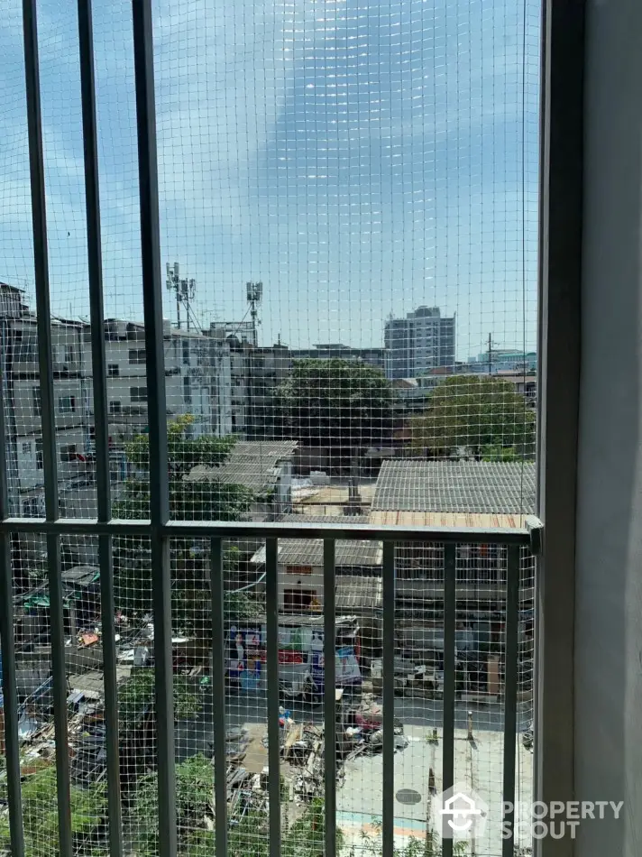 Urban view from balcony with cityscape and buildings under clear sky