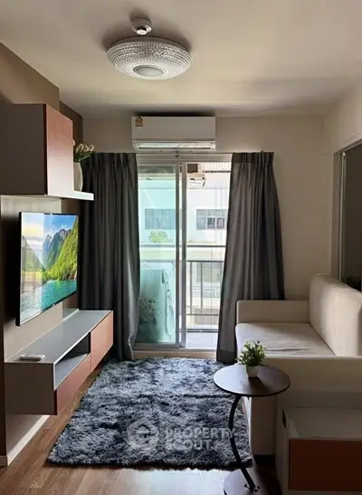Modern living room with balcony access, featuring sleek furniture and a cozy atmosphere.