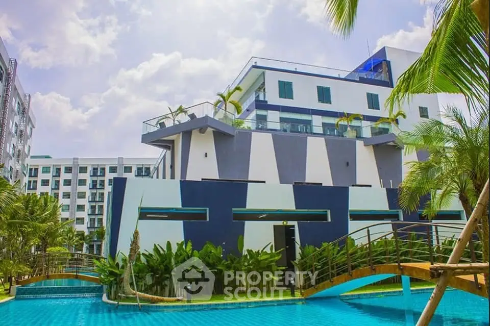 Modern building with pool and lush greenery, perfect for luxurious living.