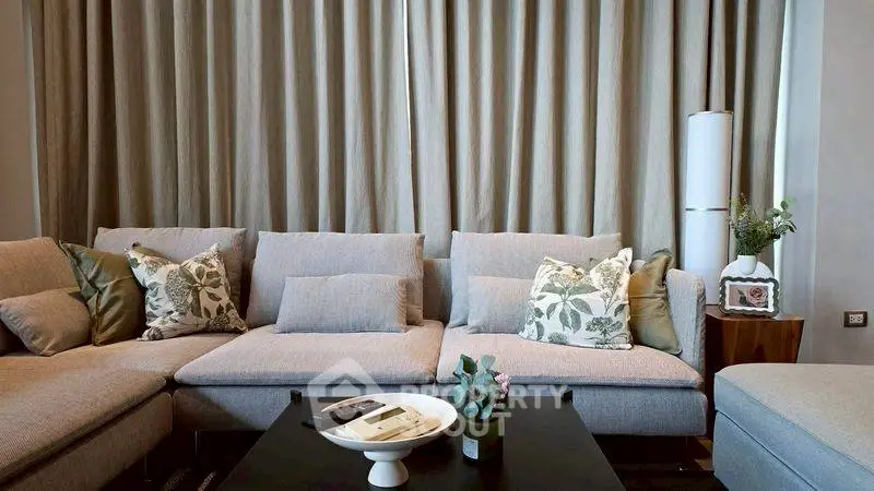 Elegant living room with plush sofa and stylish decor, perfect for relaxation and entertaining.
